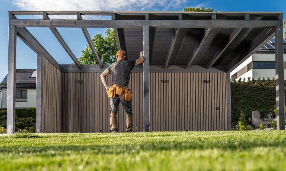 Contractor reviewing a partially built backyard structure, the kind of situation where an alta survey would reveal setback or easement issues