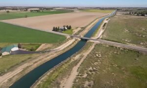Aerial view of a rural property showing an irrigation canal cutting through open land, illustrating how water easements affect usable space in an area where an alta land survey is commonly used before property purchase