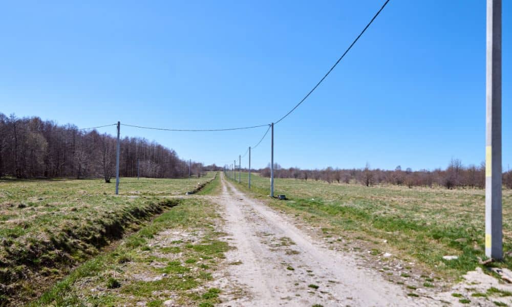 Rural Idaho land with a dirt access road and overhead utility lines