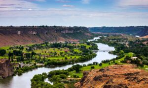 Snake River in Idaho with surrounding cliffs and farmlands highlighting environmental impacts relevant to an ALTA Land Title Survey