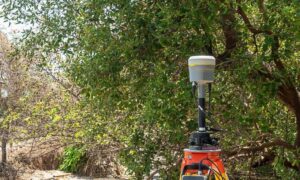 Surveyor’s GNSS equipment set up on a wooded site during an ALTA Land Title Survey, showing the modern tools used under the 2026 standards