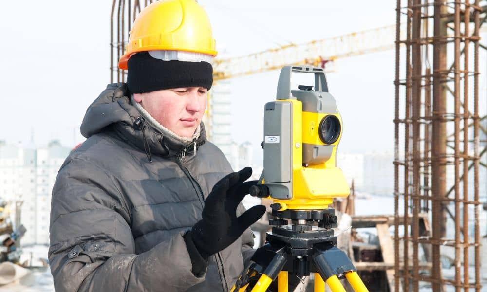 Surveyor checking equipment commercial site - ALTA SURVEY Idaho Land surveyor using total station on a commercial site for an ALTA Land Title Survey after court ruling on title documentation