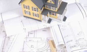 Property plans house model financing - ALTA SURVEY Idaho Model house placed on property plans showing how an ALTA title survey supports lender review and loan approval