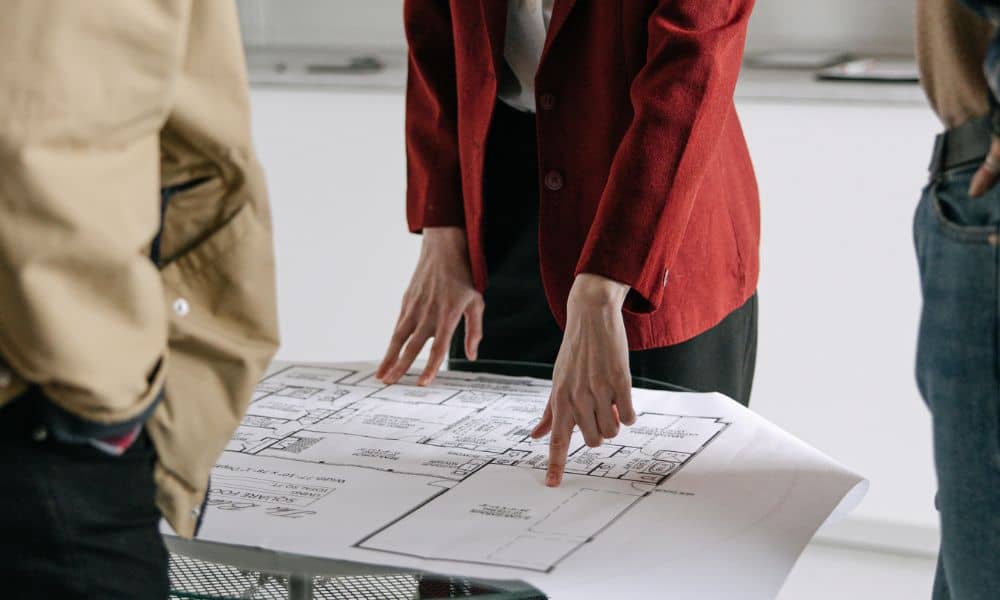 Real estate survey review meeting - ALTA SURVEY Idaho Team reviewing documents during an ALTA land title survey for a real estate transaction