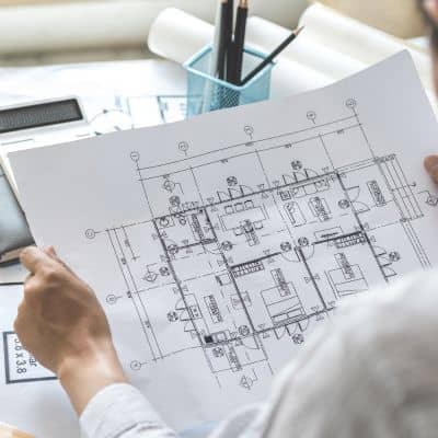 Engineer reviewing technical drawings to understand how ALTA survey pricing is calculated