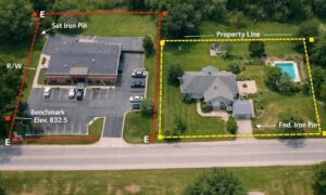 Aerial view comparing a commercial site and a residential lot with marked boundaries, similar to details shown in an ALTA land title survey