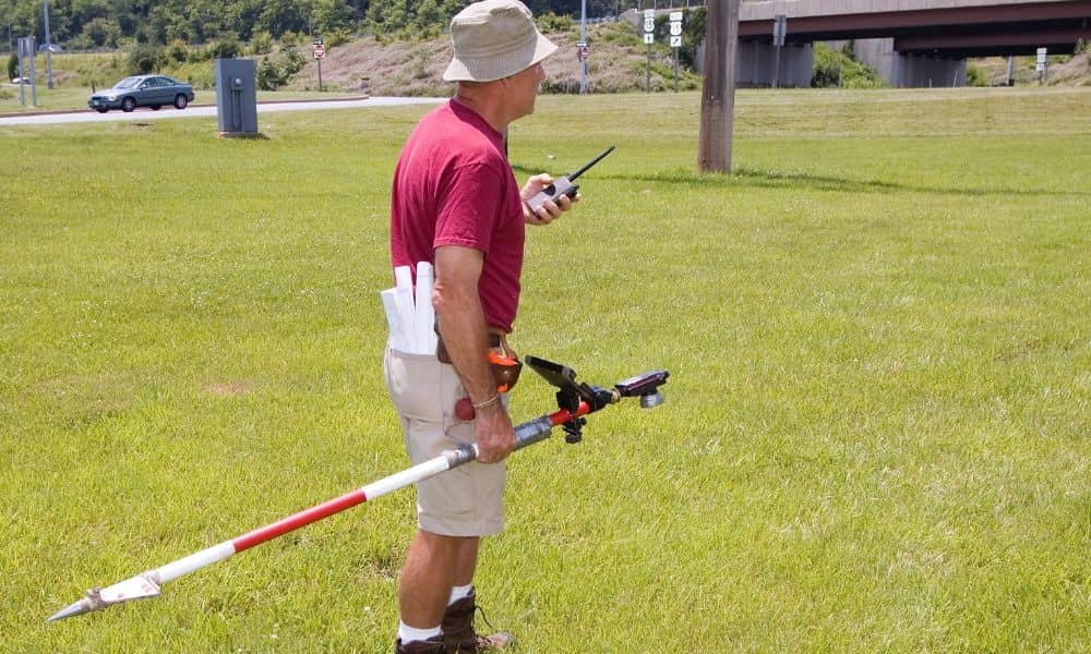 Surveyor collecting GPS boundary measurements for an ALTA land title survey
