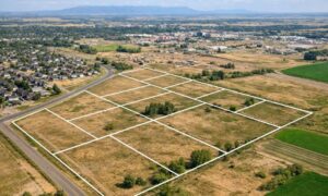 Aerial view of land parcels near a growing city showing property boundaries used during an ALTA Survey