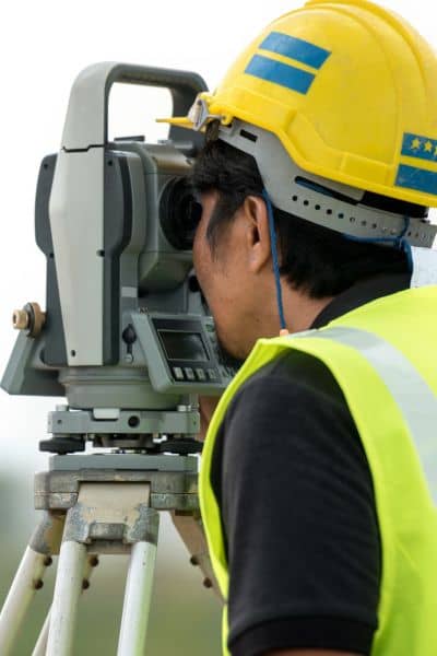 Alta survey field setup - ALTA SURVEY Idaho Surveyor using equipment to conduct an ALTA land title survey in the field